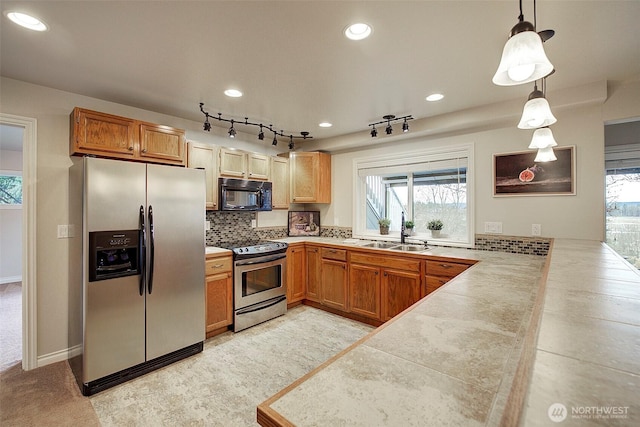 kitchen with backsplash, pendant lighting, recessed lighting, stainless steel appliances, and a sink