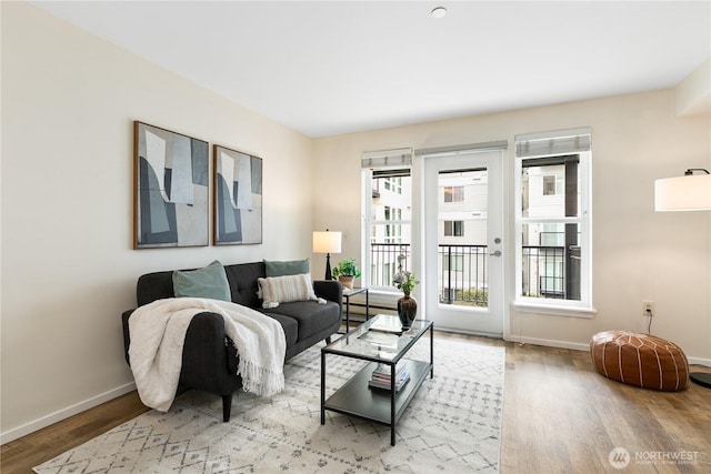 living area featuring baseboards and wood finished floors