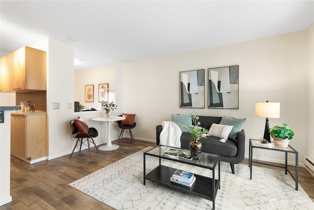 living area with baseboards and wood finished floors