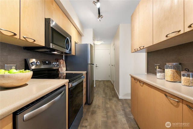 kitchen featuring dark wood-type flooring, light brown cabinetry, stainless steel appliances, light countertops, and decorative backsplash