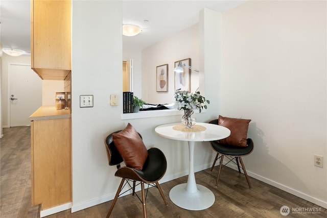 dining area featuring wood finished floors, baseboards, and breakfast area