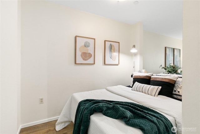 bedroom featuring baseboards and wood finished floors