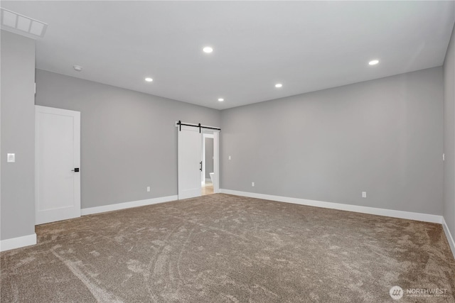 empty room featuring carpet, a barn door, recessed lighting, and visible vents