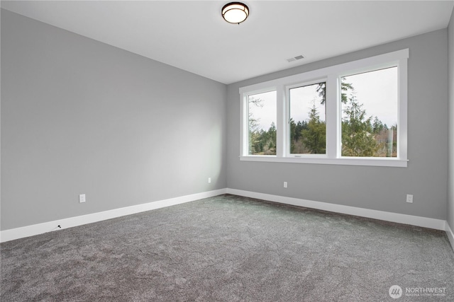 empty room with visible vents, baseboards, and carpet flooring