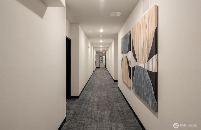 corridor featuring dark colored carpet and visible vents