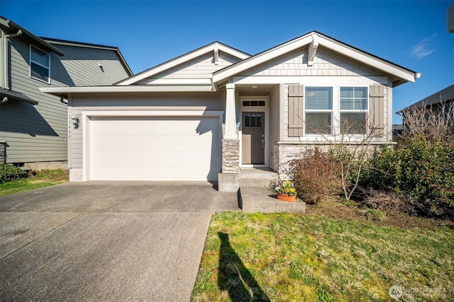 craftsman house featuring stone siding, driveway, and a garage