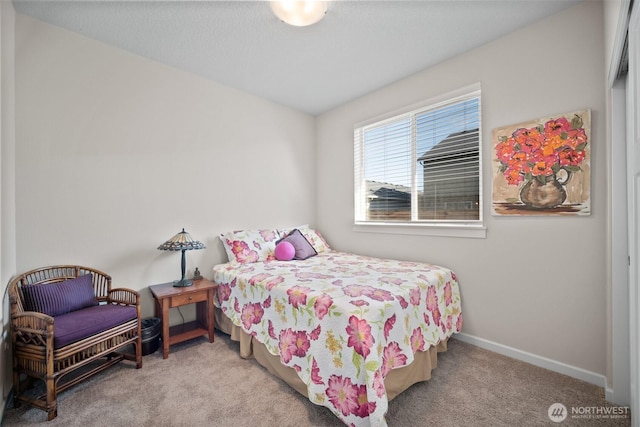 carpeted bedroom featuring baseboards