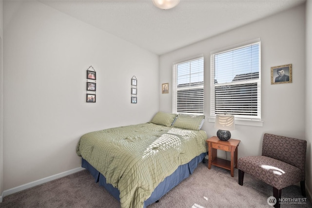 carpeted bedroom featuring baseboards