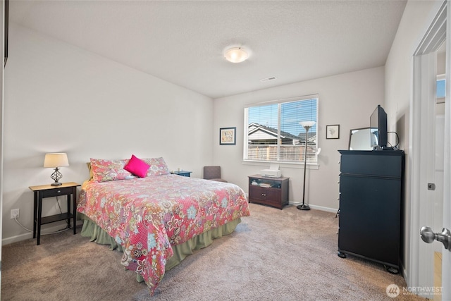 bedroom with visible vents, baseboards, and carpet