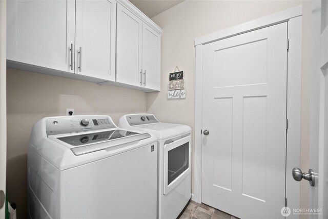 washroom with cabinet space and separate washer and dryer