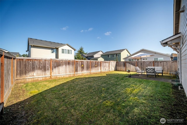 view of yard with a residential view and a fenced backyard