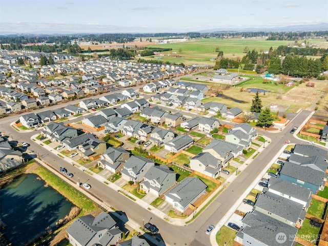 drone / aerial view featuring a residential view and a water view