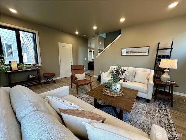 living room with recessed lighting, baseboards, and wood finished floors