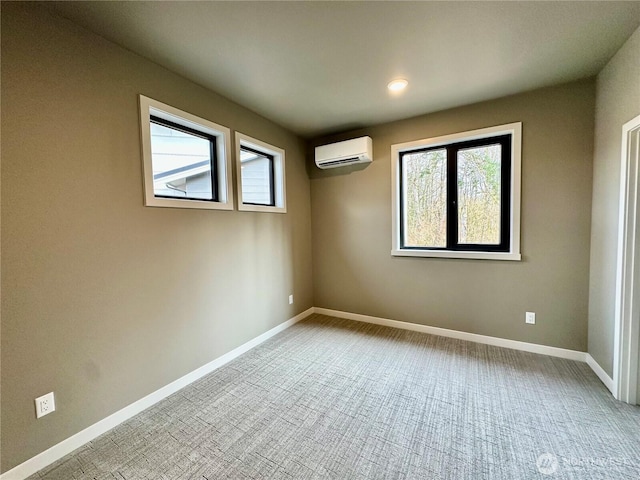 unfurnished room with an AC wall unit, plenty of natural light, carpet, and baseboards