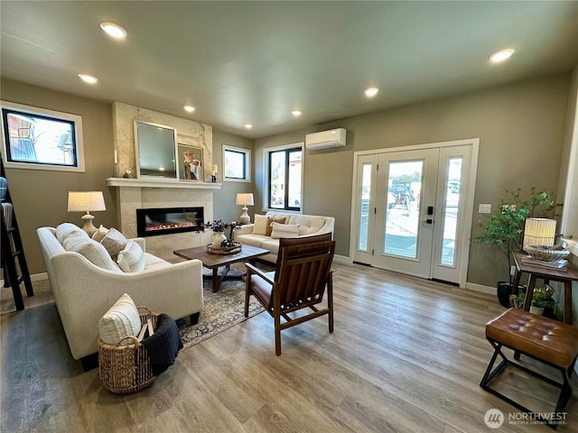 570 Creston Ct, Bellingham, WA 98226 - living room with a wall mounted AC, a premium fireplace, wood finished floors, recessed lighting, and baseboards