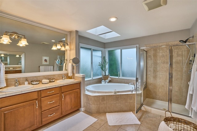 full bathroom with a sink, a shower stall, a bath, and tile patterned floors