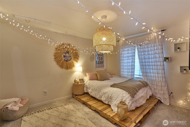 carpeted bedroom featuring baseboards