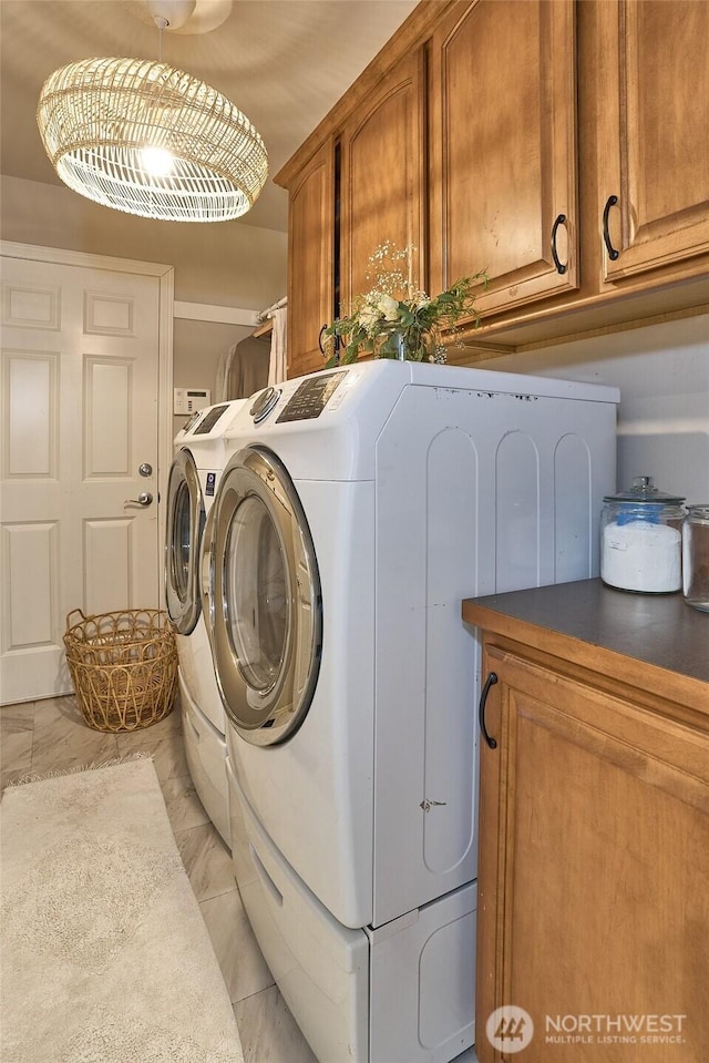 laundry room with washer and dryer and cabinet space