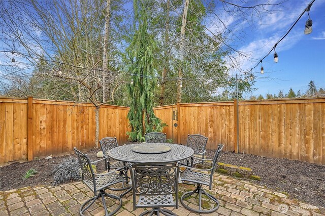 view of patio with outdoor dining area and a fenced backyard