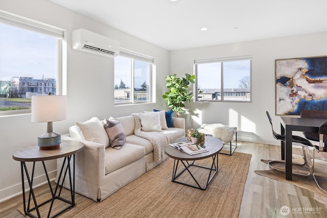 living area with a wall unit AC, recessed lighting, wood finished floors, and baseboards