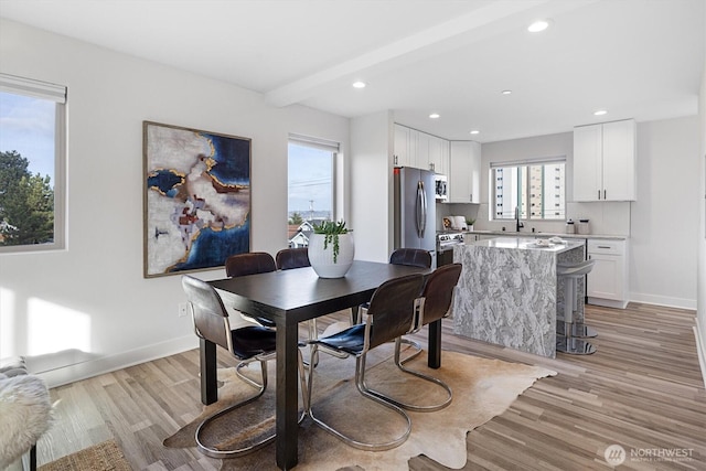 dining room featuring recessed lighting, light wood-type flooring, and baseboards