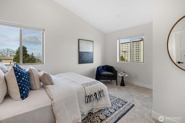 bedroom with lofted ceiling, baseboards, and carpet floors