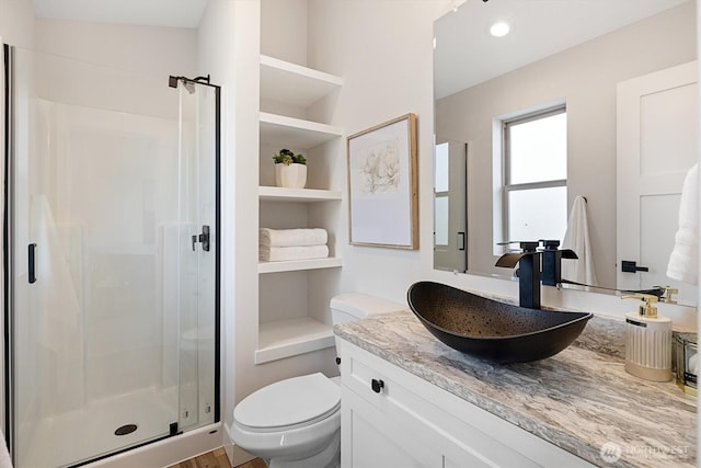 full bath with built in shelves, toilet, recessed lighting, a stall shower, and vanity