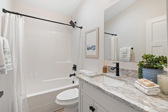 bathroom with vanity, toilet, and shower / bath combo