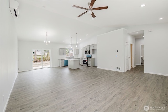 unfurnished living room featuring visible vents, ceiling fan with notable chandelier, baseboards, and light wood-style floors