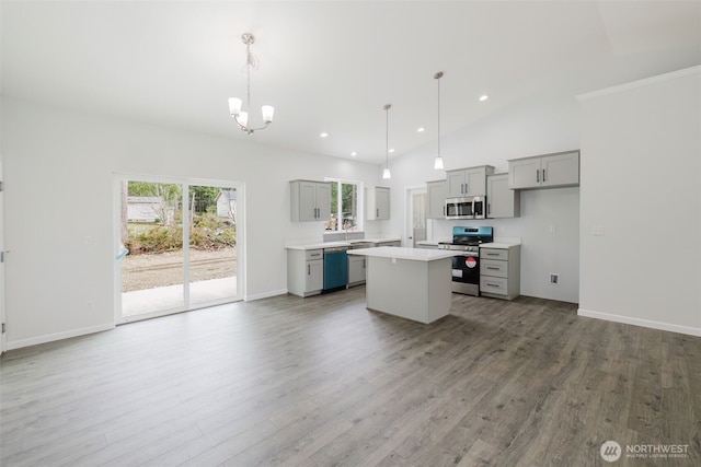 kitchen with light countertops, a kitchen island, gray cabinets, and stainless steel appliances