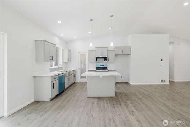 kitchen featuring a sink, appliances with stainless steel finishes, gray cabinets, and light countertops