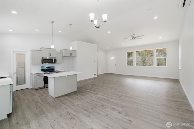 kitchen with gray cabinetry, a center island, light countertops, appliances with stainless steel finishes, and light wood-style floors