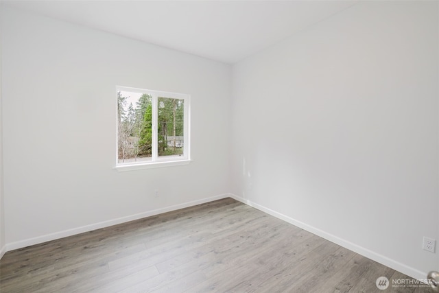 unfurnished room featuring wood finished floors and baseboards