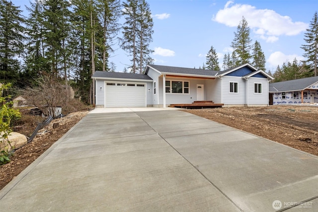 single story home with a garage and concrete driveway