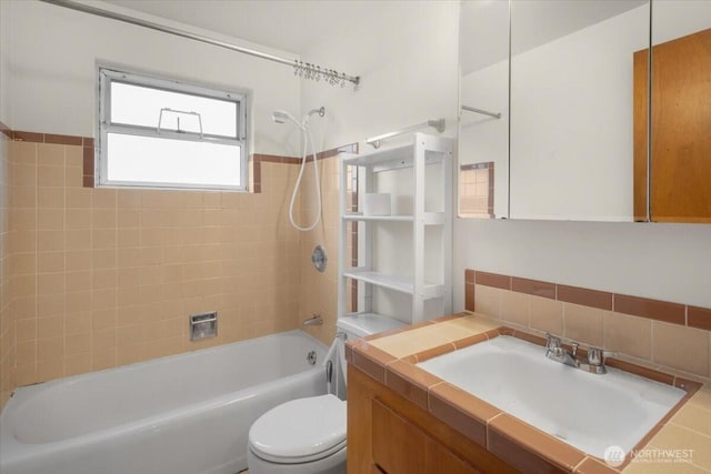 bathroom featuring vanity, shower / bathing tub combination, and toilet