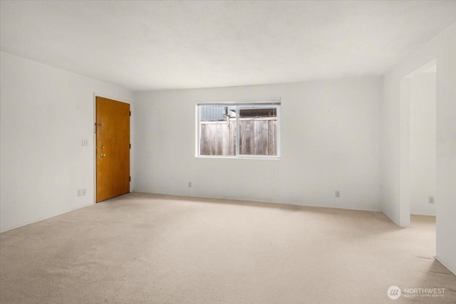 spare room with light colored carpet