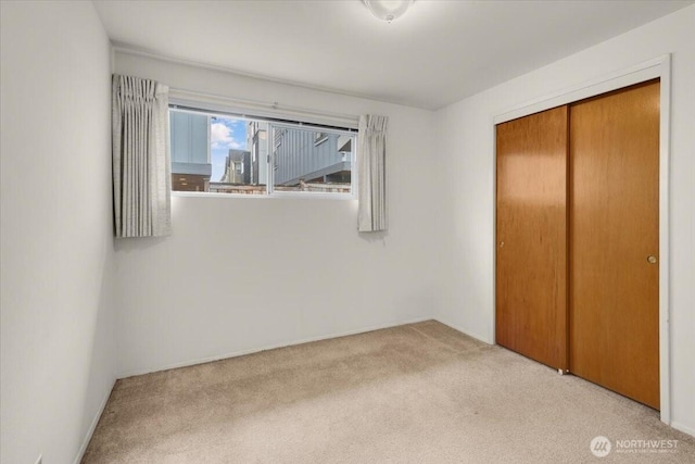 unfurnished bedroom with a closet and carpet