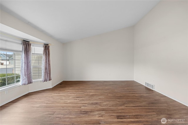 empty room featuring visible vents and wood finished floors