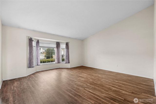 spare room featuring wood finished floors