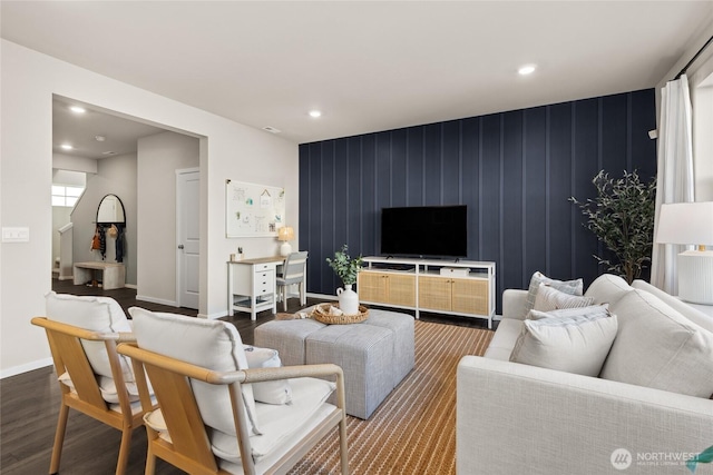 living area featuring an accent wall, recessed lighting, wood finished floors, and baseboards