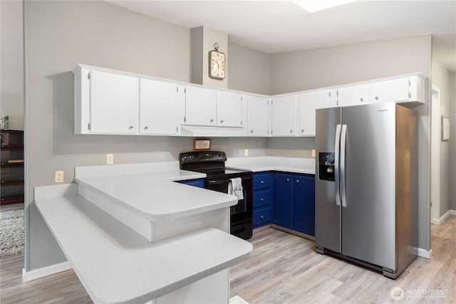 kitchen featuring black range with electric stovetop, blue cabinetry, a peninsula, stainless steel fridge with ice dispenser, and light countertops