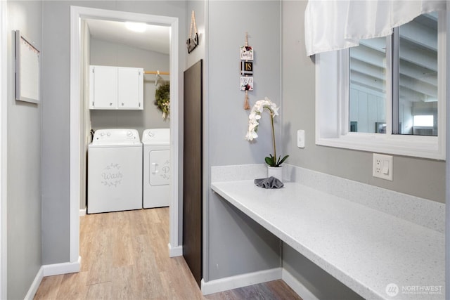 bathroom with vaulted ceiling, washing machine and dryer, baseboards, and wood finished floors