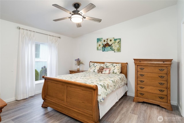 bedroom with baseboards, light wood-style floors, and ceiling fan