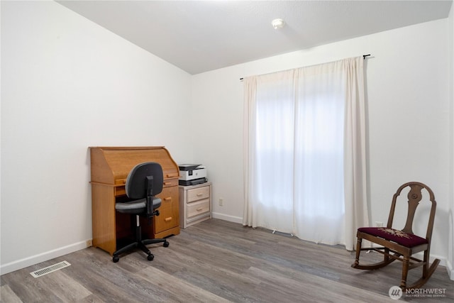 office area featuring visible vents, baseboards, and wood finished floors