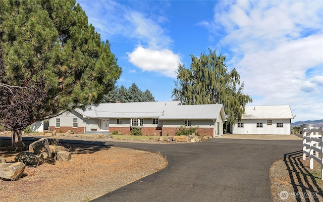 single story home with brick siding and driveway