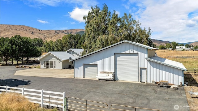 exterior space with fence and a mountain view