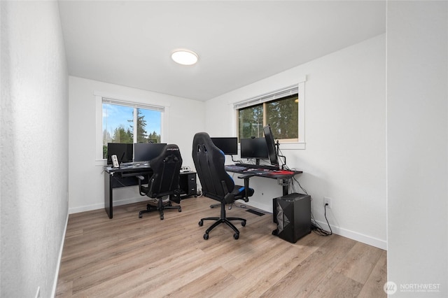 home office with baseboards and wood finished floors