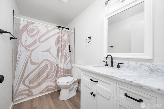 full bath featuring vanity, toilet, and wood finished floors