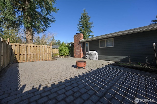 view of patio / terrace featuring a fire pit and a fenced backyard