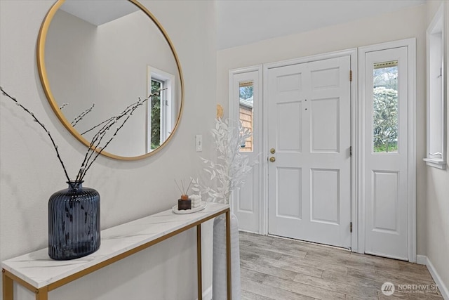 entrance foyer with light wood-style flooring and a healthy amount of sunlight